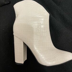 Heeled white booties